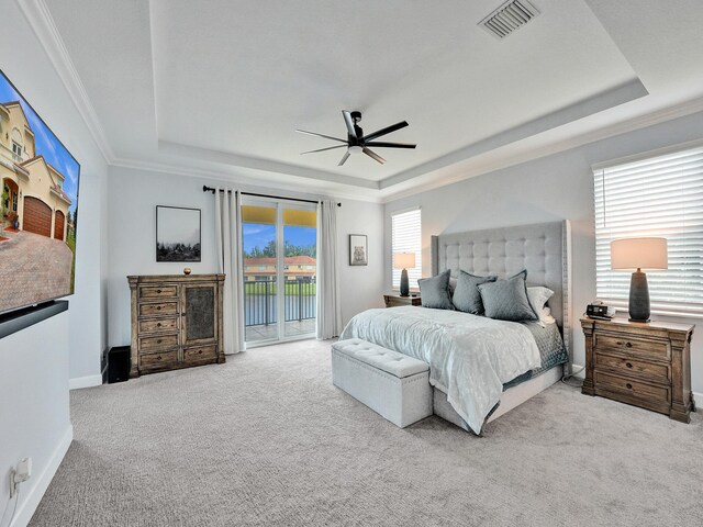 bedroom featuring access to outside, light carpet, ceiling fan, and a raised ceiling