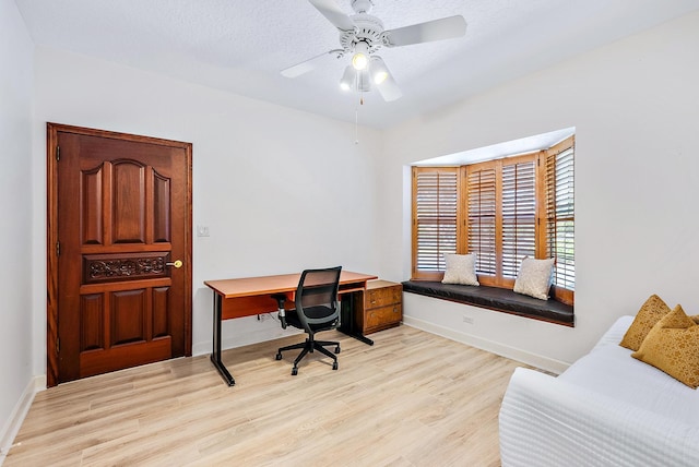 office area with light wood-type flooring and ceiling fan