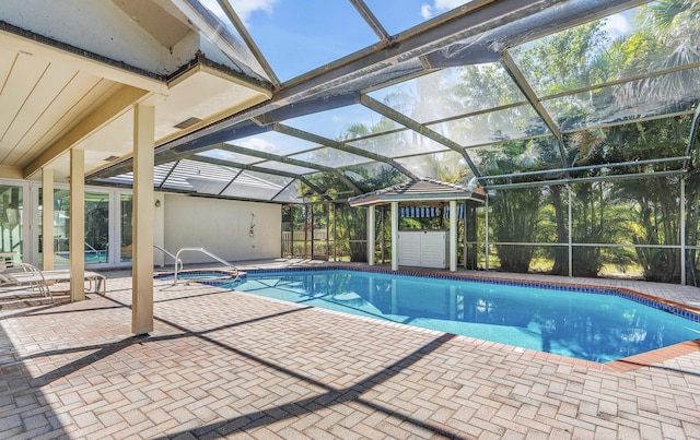 view of swimming pool with a patio and a lanai