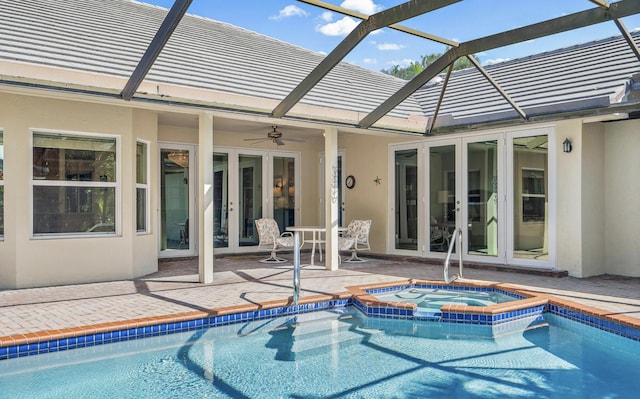 view of pool with an in ground hot tub, a patio area, and ceiling fan