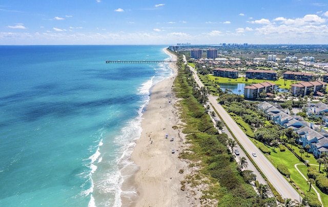 bird's eye view featuring a water view and a beach view