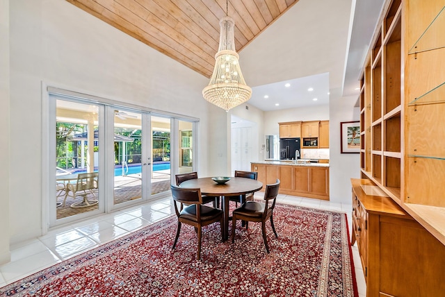 tiled dining room with a notable chandelier, french doors, wooden ceiling, and high vaulted ceiling