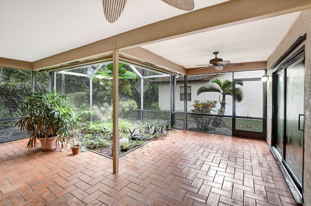 unfurnished sunroom with ceiling fan