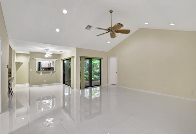 tiled empty room featuring vaulted ceiling and ceiling fan