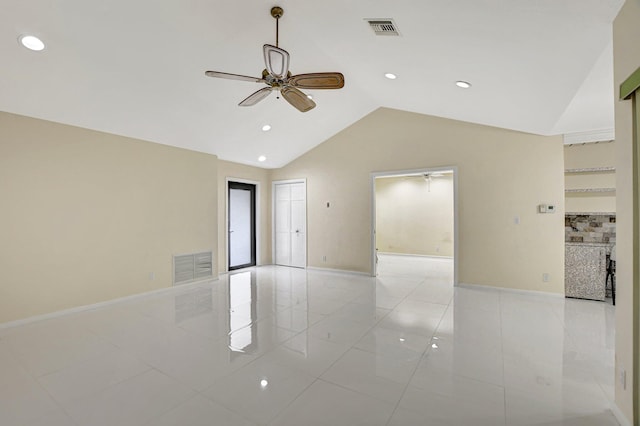 tiled spare room featuring ceiling fan and lofted ceiling