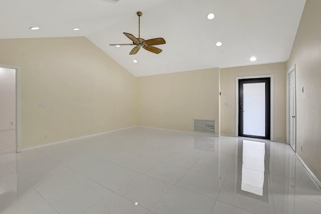 tiled spare room featuring vaulted ceiling and ceiling fan