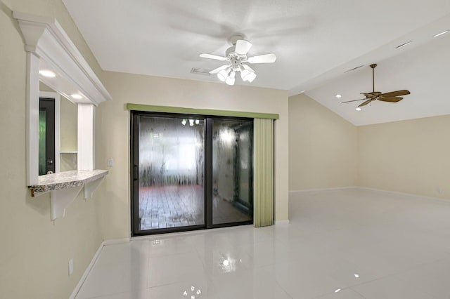 empty room featuring ceiling fan and vaulted ceiling