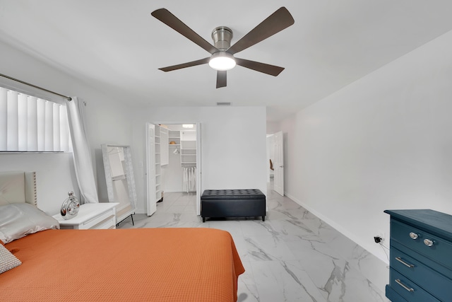 bedroom featuring a spacious closet, a closet, and ceiling fan