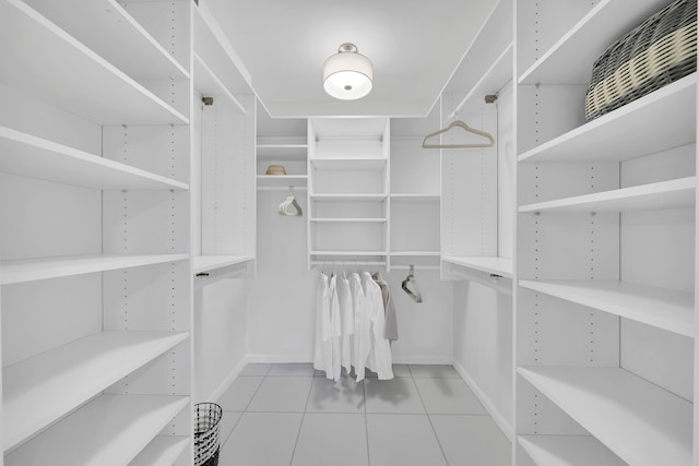 spacious closet with light tile patterned floors