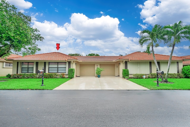 ranch-style home with a garage and a front lawn