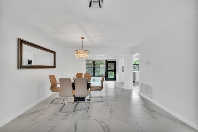 dining space with an inviting chandelier