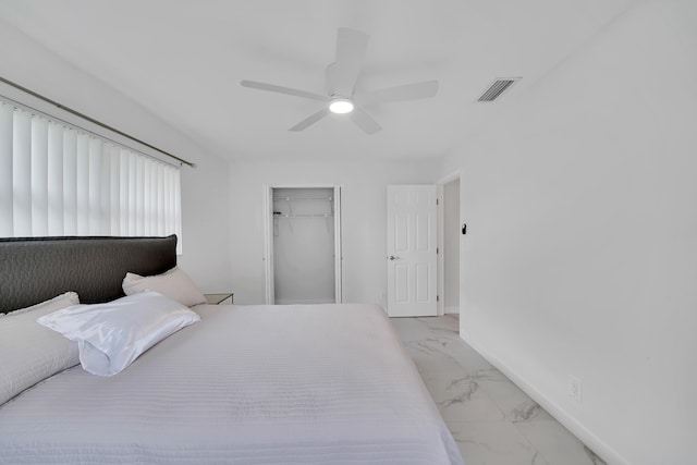 bedroom with ceiling fan, a closet, and a walk in closet