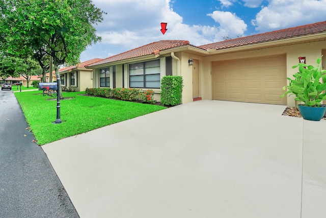 view of front facade with a garage and a front lawn