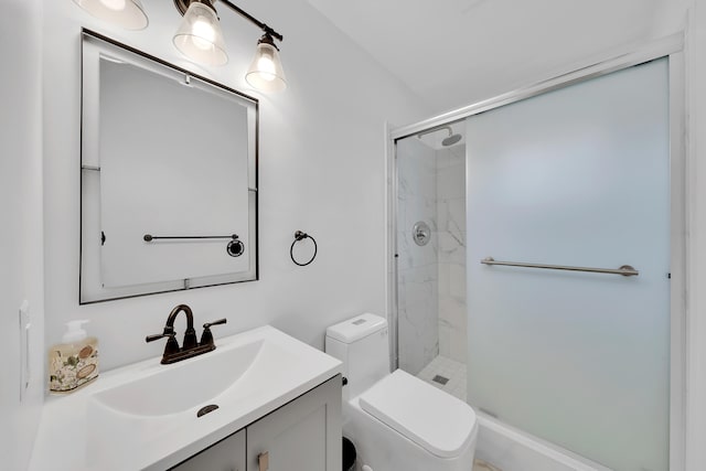 bathroom with an enclosed shower, vanity, and toilet