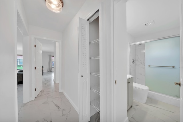 bathroom with toilet, vanity, and walk in shower