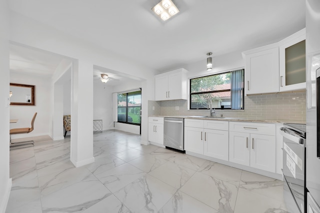 kitchen featuring stainless steel appliances, white cabinets, tasteful backsplash, and sink