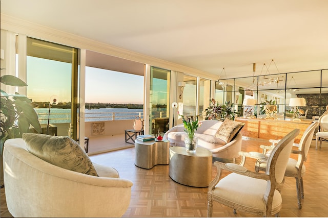 living room with light parquet flooring, crown molding, and a water view