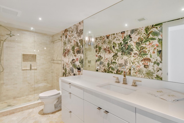 bathroom with toilet, a shower with shower door, and vanity