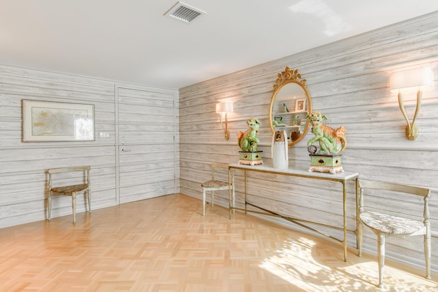 interior space featuring wood walls and parquet flooring