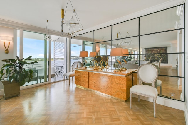 sunroom / solarium with an inviting chandelier and a water view