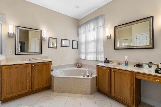 bathroom featuring tiled tub, vanity, and tile patterned floors