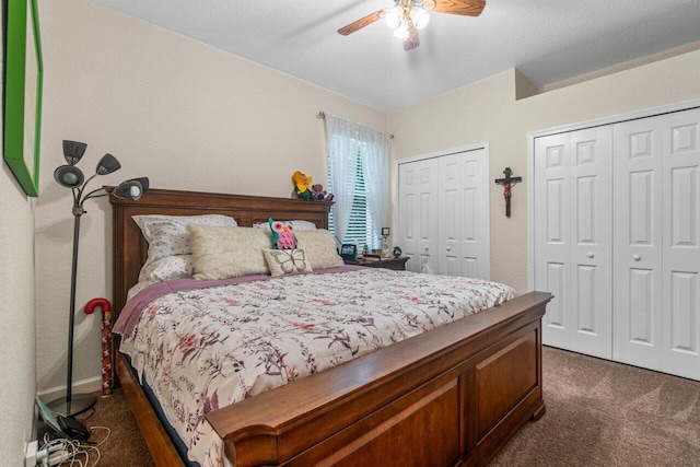 carpeted bedroom featuring ceiling fan and multiple closets