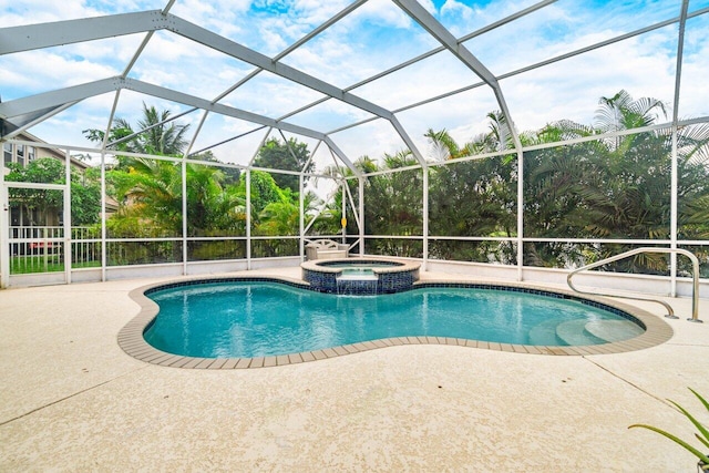 view of swimming pool featuring a patio, an in ground hot tub, and a lanai