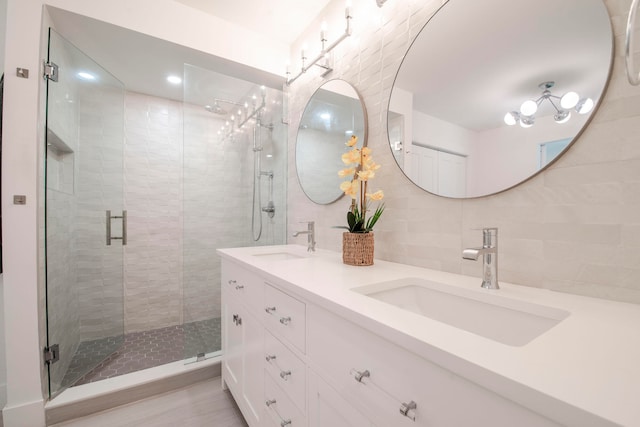 bathroom featuring vanity, decorative backsplash, walk in shower, and tile walls