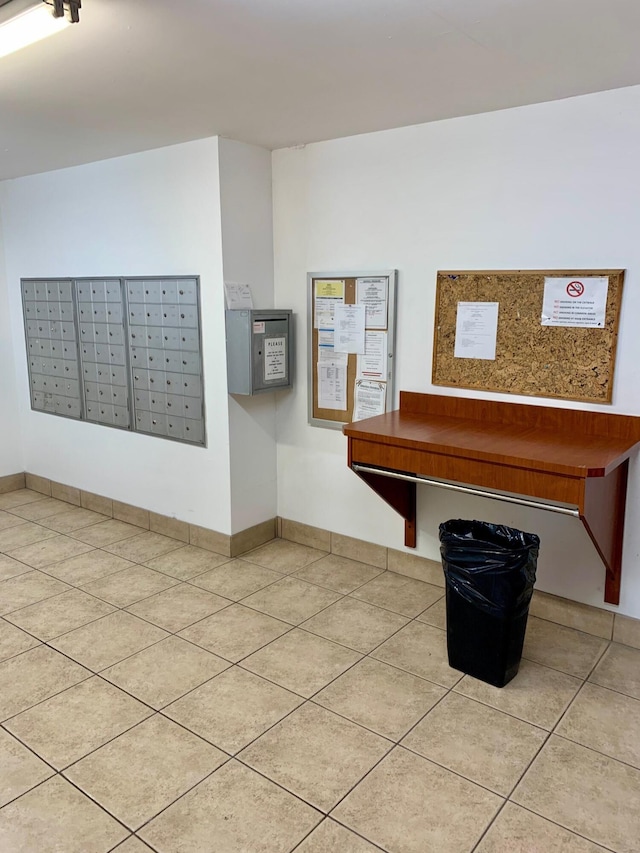 interior space featuring tile patterned floors and a mail area