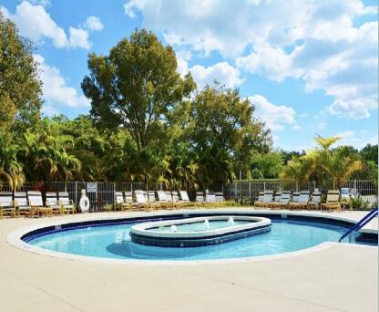 view of pool with a patio and a community hot tub