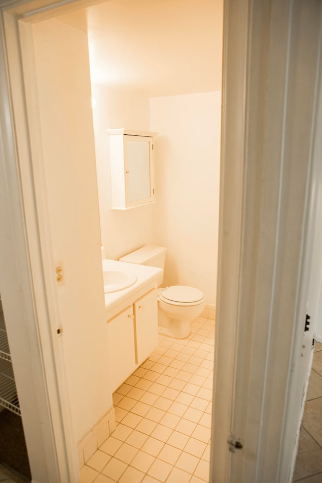 bathroom with vanity, toilet, and tile patterned flooring