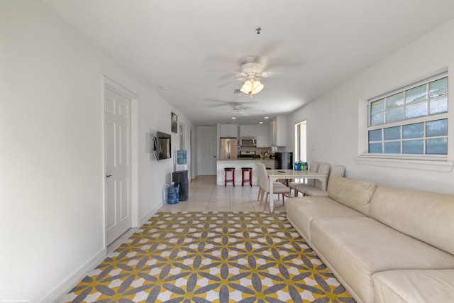 living room with light tile patterned floors and ceiling fan