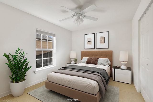 bedroom featuring light tile patterned flooring and ceiling fan