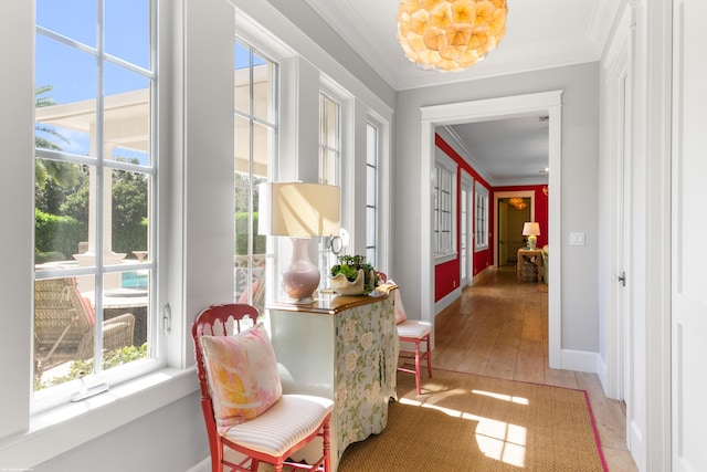 hallway with ornamental molding and hardwood / wood-style flooring