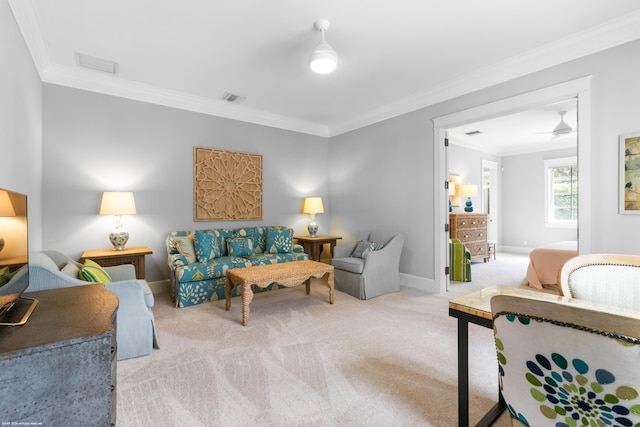 carpeted living room with ceiling fan and ornamental molding