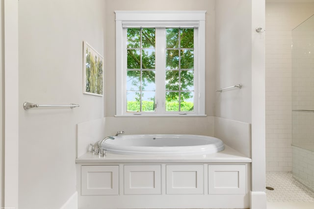 bathroom featuring separate shower and tub