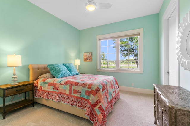 bedroom with light carpet and ceiling fan