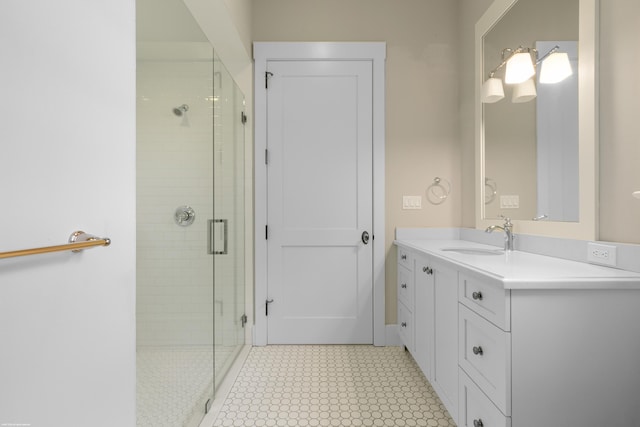 bathroom featuring a shower with door and vanity