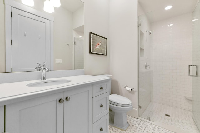 bathroom with a shower with door, toilet, tile patterned floors, and vanity