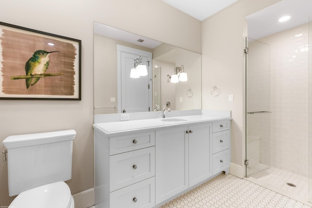 bathroom featuring vanity, toilet, and an enclosed shower