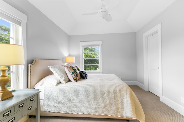 bedroom with lofted ceiling, light carpet, and ceiling fan