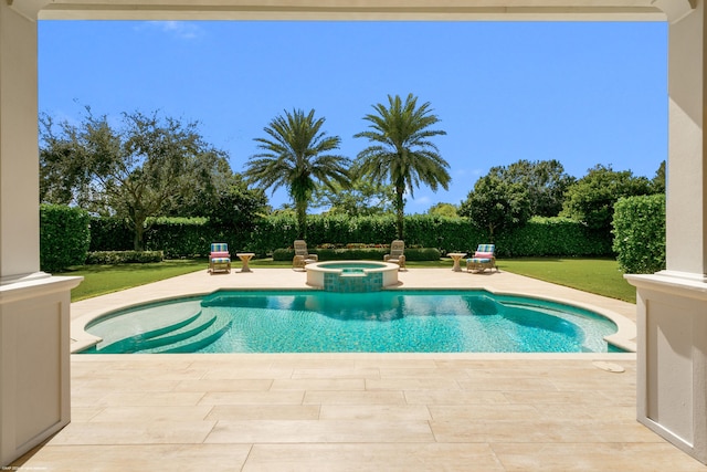 view of pool with an in ground hot tub, a yard, and a patio area