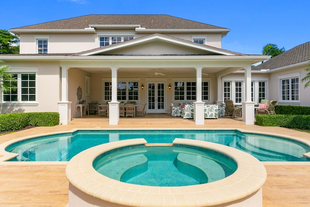 back of house featuring a patio, french doors, and a pool with hot tub