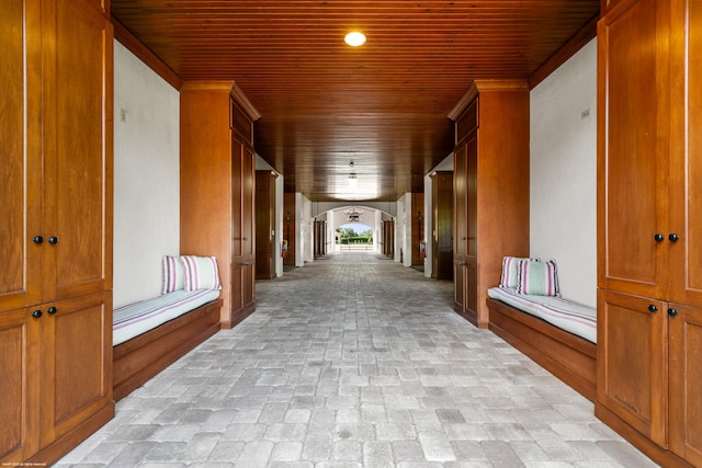 hall with crown molding and wooden ceiling