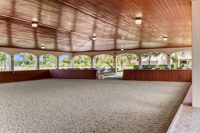 unfurnished sunroom featuring wooden ceiling and vaulted ceiling