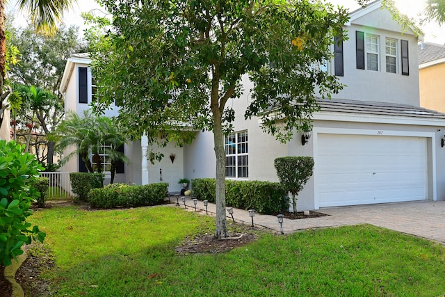 view of front facade with a garage and a front lawn