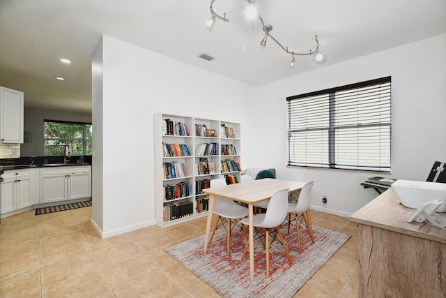 tiled dining area featuring sink