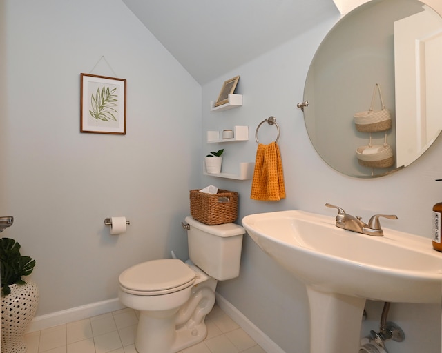 bathroom featuring toilet, lofted ceiling, sink, and tile patterned flooring