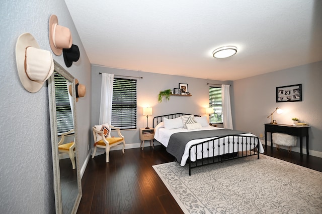 bedroom with dark hardwood / wood-style floors