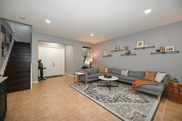 tiled living room featuring a textured ceiling